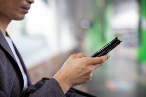 Close-up of man's hand using smart phone