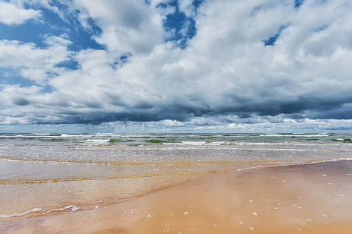 Sea landscape with a dramatic cloudy sky, and windy weather on the Baltic seashore. Latvia
