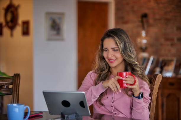 istock Hispanic young woman using tablet at home with copy space 1410710061