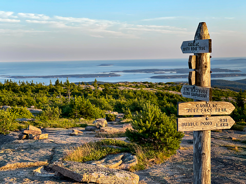 Directional sign overlooks the ocean in Bar Harbor from the top of Cadillac Mountain in Acadia National Park.