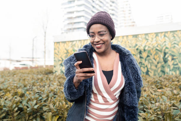 istock Young African woman using mobile phone 1410713433