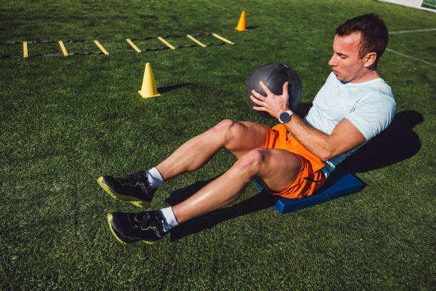 istock Athlete doing medicine ball exercise for abs 1410713673