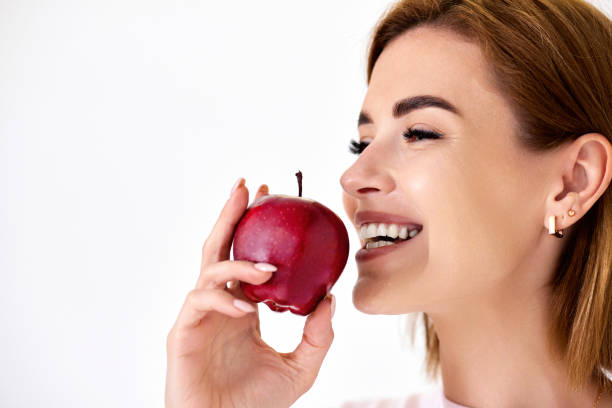 istock girl holding green apple isolated on white background 1410714040