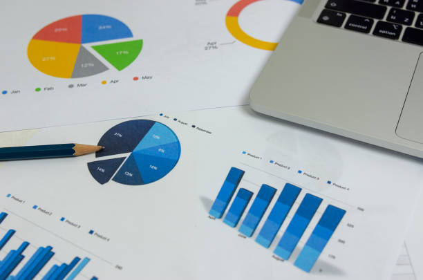 istock Business document graph finance report statistic analysis and chart investment information with computer laptop on desk at office. 1410714106