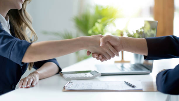 Man and woman are shaking hands in office. Collaborative teamwork. Man and woman are shaking hands in office. Collaborative teamwork. gripping stock pictures, royalty-free photos & images