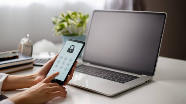 istock User holding mobile phone and pressing password on the screen to log in. 1410722344