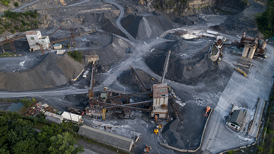 Loading railway gondola cars with a dragline excavator at a warehouse in a clay quarry. Zaporizhia region, Ukraine. April 2015