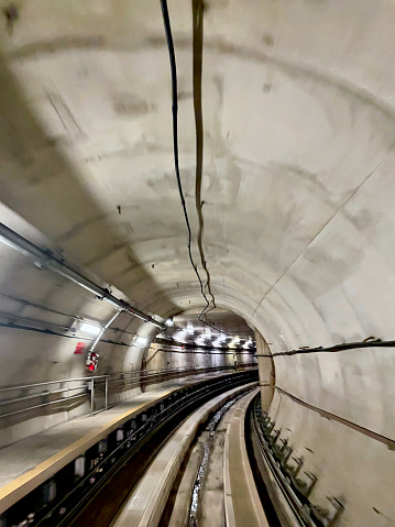 Sterling, Virginia, USA - July 10, 2022: Passenger view from inside the AeroTrain tunnel that transports domestic and international passengers underground between the Washington Dulles International Airport Terminal and its midfield gates.