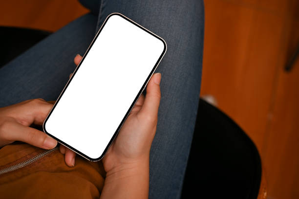 istock Overhead, Female using smartphone to chat with someone. Phone white screen mockup 1410731652