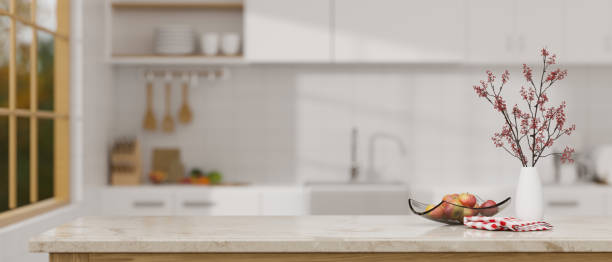 istock Elegance marble kitchen tabletop with decors and copy space over blurred kitchen background. 1410731680