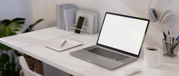 istock Modern white office desk with laptop mockup and office accessories. close-up image. 1410731706