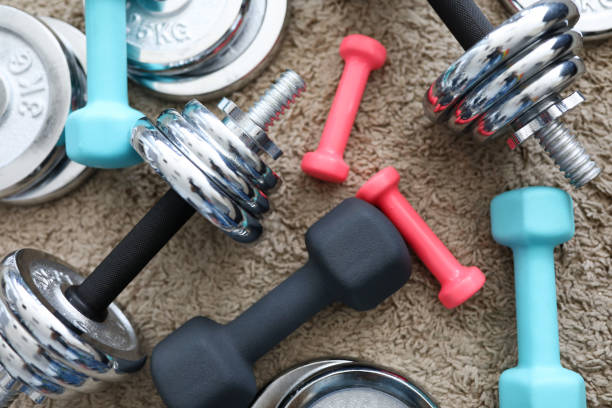 istock Pile of chrome dumbbells disks lying around grip 1410735580