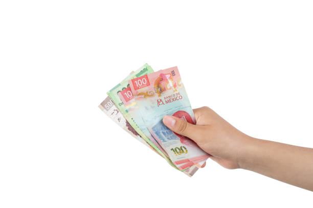 Outstretched hand holding banknotes, making the gesture of paying, with white background and copy space.