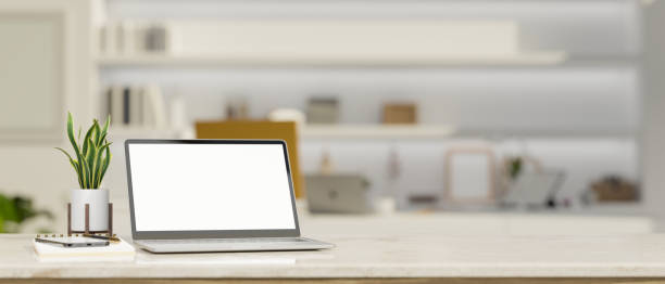 istock Workspace tabletop with notebook laptop mockup and copy space over blurred modern home studio 1410741448