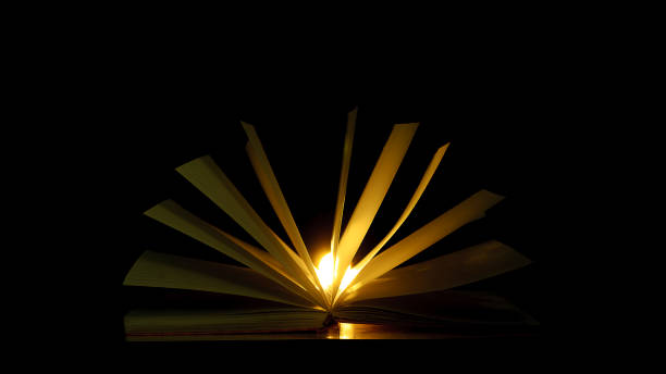 istock Bewitched Book With Magic Glows In The Darkness with the lines   and lights 1410741707