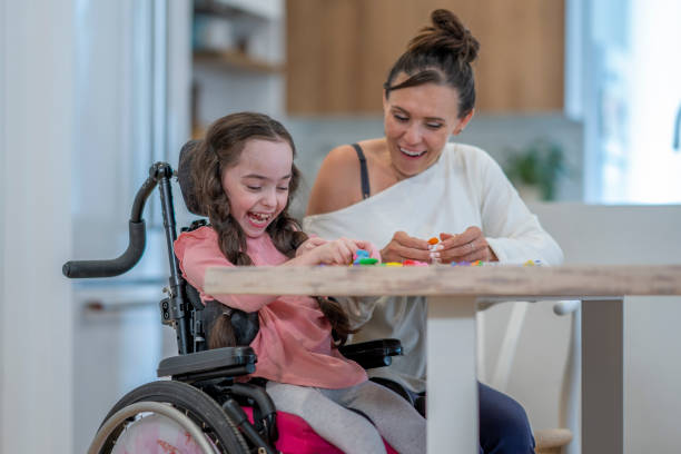 istock Social Worker with a Cerebral Palsy Patient 1410743028