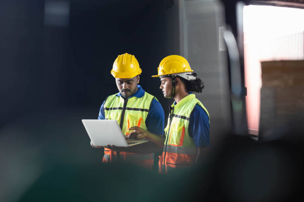 istock Selective focus workers team taking inventory in factory warehouse, Foreman workers working in warehouse talking about job 1410744222