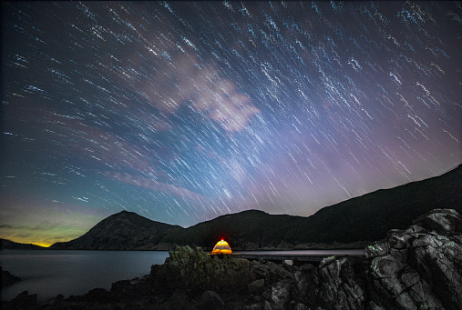 The star trail of Pak Lap Fishing Cultural Village with a camping tent