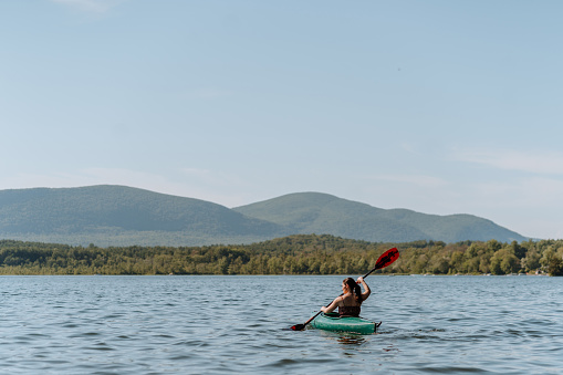 woman sailing a canoe on the lake
