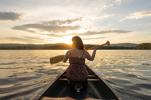 woman sailing a canoe on the lake