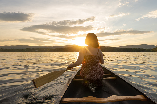 woman sailing a canoe on the lake