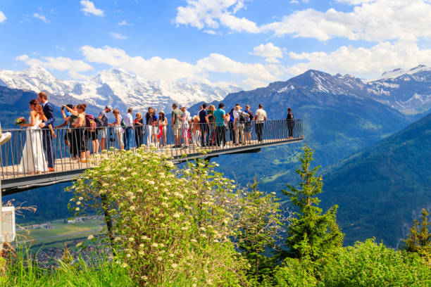 tourists standing on harder kulm viewpoint and enjoying breathtaking view of bernese alps, switzerland - interlaken imagens e fotografias de stock