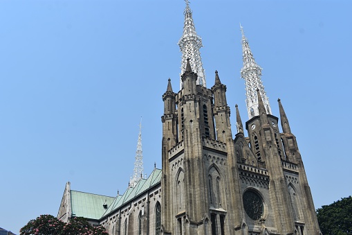 The Jakarta Cathedral Church, or officially the Church of Santa Maria Assumption (Dutch: De Kerk van Onze Lieve Vrouwe ten Hemelopneming; English: The Church of Our Lady of the Assumption) is a Catholic church in Jakarta. This church building was inaugurated in 1901 and was built with neo-gothic architecture from Europe, the architecture that was very commonly used to build church buildings several centuries ago.\n\nThe current church was designed and started by Father Antonius Dijkmans and the foundation stone was laid by the pro-vicar, Carolus Wennker. This work was then continued by Cuypers-Hulswit when Dijkmans could not continue, and was then inaugurated and blessed on 21 April 1901 by Mgr. Edmundus Sybradus Luypen, S.J., Apostolic Vicar of Jakarta.\n\nThe cathedral that we know today is actually not the original church building in that place, because the original cathedral was inaugurated in February 1810, but on July 27, 1826 the church building caught fire along with 180 houses of residents around it during a major fire. Then on May 31, 1890, the church collapsed due to structural problems so that it had to be renovated.\n\nOn Christmas Eve, December 24, 2000, this church became one of the locations that was hit by a bomb attack.