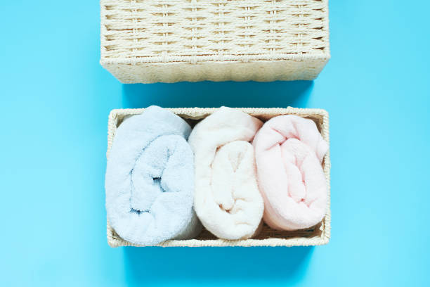 istock Towels in box on blue background top view, space organization concept. 1410750862