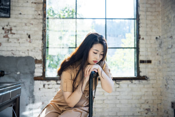 The sad woman sat on the stool