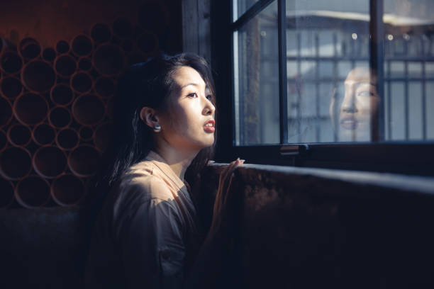 istock women looking through the window 1410751885