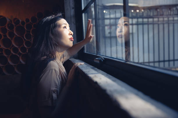 istock women looking through the window 1410751941