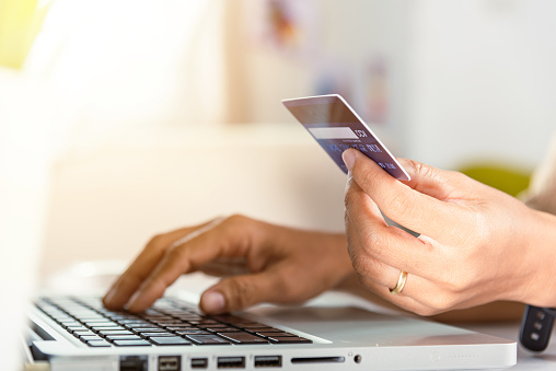 Female register via credit cards on computer make electronic payment security online, Woman hands holding credit card and using laptop with product purchase at home, Internet online shopping concept