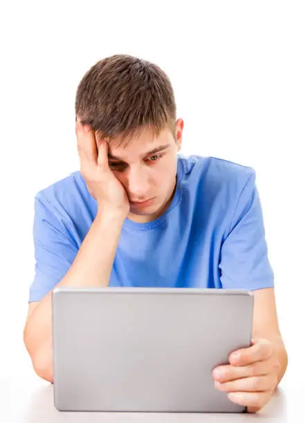 Sad Young Man with Tablet Computer Isolated on the White Background