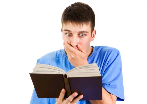 Surprised Young Man read a Book Isolated on the White Background