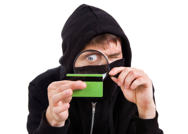 hacker with a bank card - snooper imagens e fotografias de stock