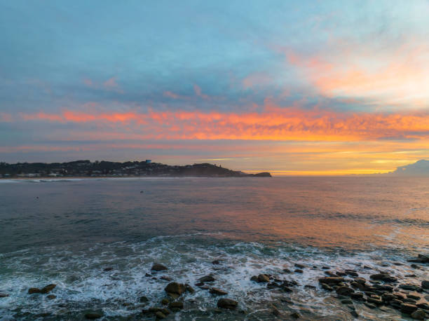 istock Sunrise over the sea with high cloud filled sky 1410755037
