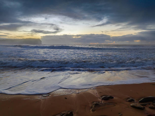 istock Sunrise at the seaside with large and powerful sets 1410755094