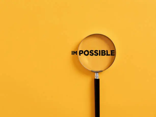 Photo of Magnifier focuses on the possible side of the word impossible.