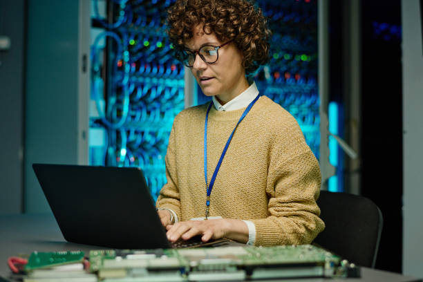 istock Engineer woman working with laptop in data center 1410757653