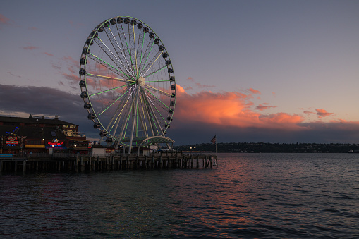 Seattle, USA - Jun 23, 2022: Sunset on the waterfront with the Seattle Great Wheel.