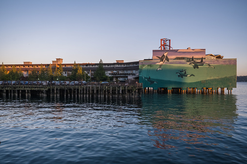 Seattle, USA - Jul 20, 2022: Sunset on the waterfront with the Edgewater Hotel made famous as the hotel the Beatles fished from the balcony.