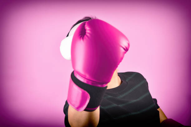 Asian man hitting a punch by vr glasses, Working out with boxing video games application from virtual reality headset, Young man enjoy new fitness experience by vr technology, Studio shot.