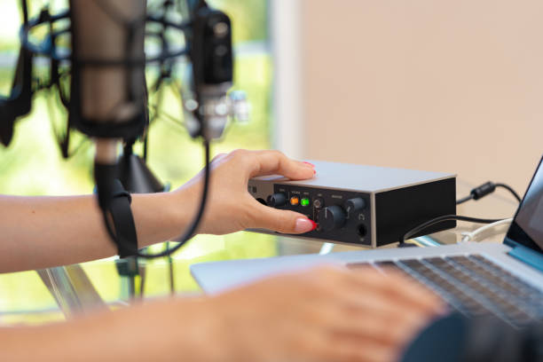 istock Unrecognizable young woman hands adjusting audio mixer setting sound in home studio close up 1410760193