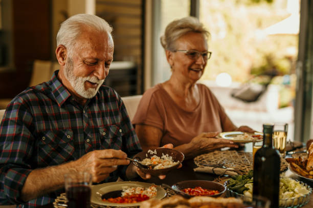 istock Senior couple having lunch at home 1410762312