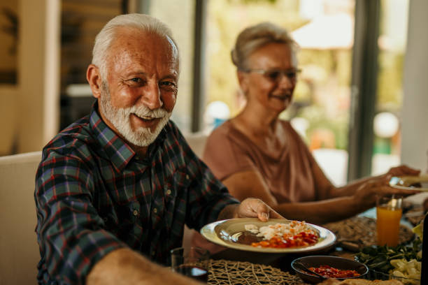 istock Senior couple having lunch at home 1410762327