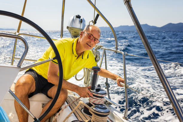 istock Sailing crew member trimming genoa sail on sailboat 1410763642
