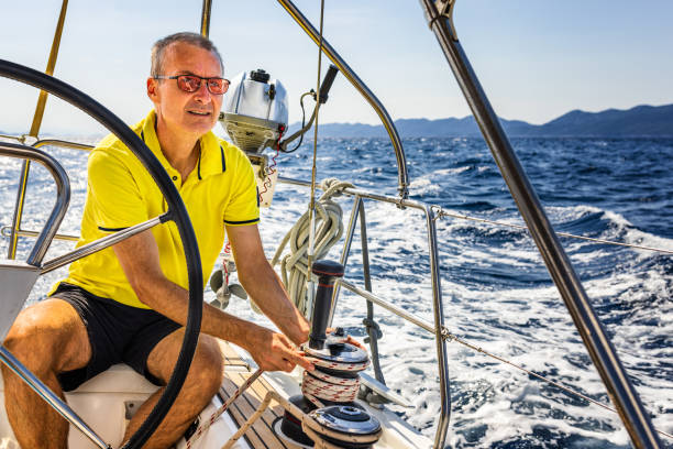 istock Sailing crew member trimming genoa sail on sailboat 1410763666
