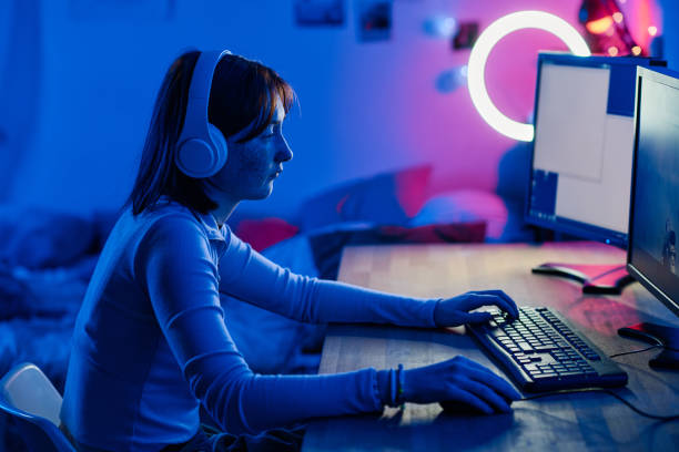 istock Teenage girl playing video game on computer 1410763994