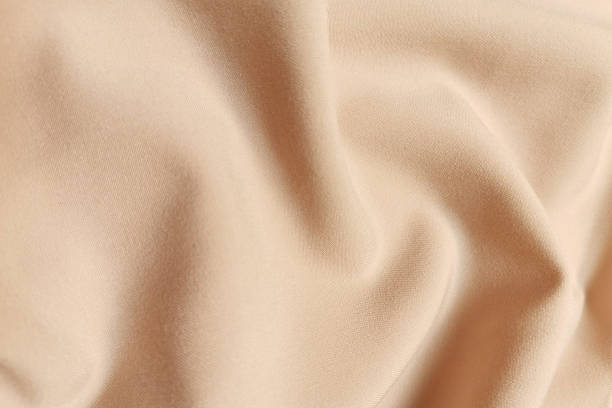 istock Beige galliano fabric crumpled or wavy fabric texture background. Abstract linen cloth soft waves. Viscose yarn. Smooth elegant luxury cloth texture. Concept for banner or advertisement 1410764222