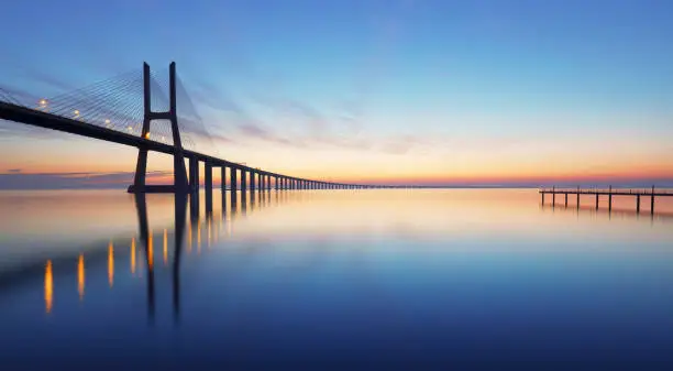 Photo of Lisbon bridge - Vasco da Gama at sunrise, Portugal